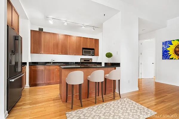 252 7th Avenue, Unit 10I Manhattan, NY 10001 - Photo 3 of 25 a living room with stainless steel appliances kitchen island granite countertop a refrigerator and a stove top oven