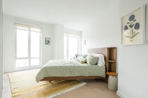 a bedroom with a bed and wooden floor