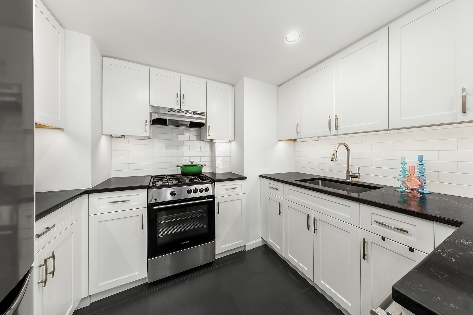 251 East 32nd Street, Unit 19F Manhattan, NY 10016 - Photo 4 of 13 a kitchen with white cabinets and appliances