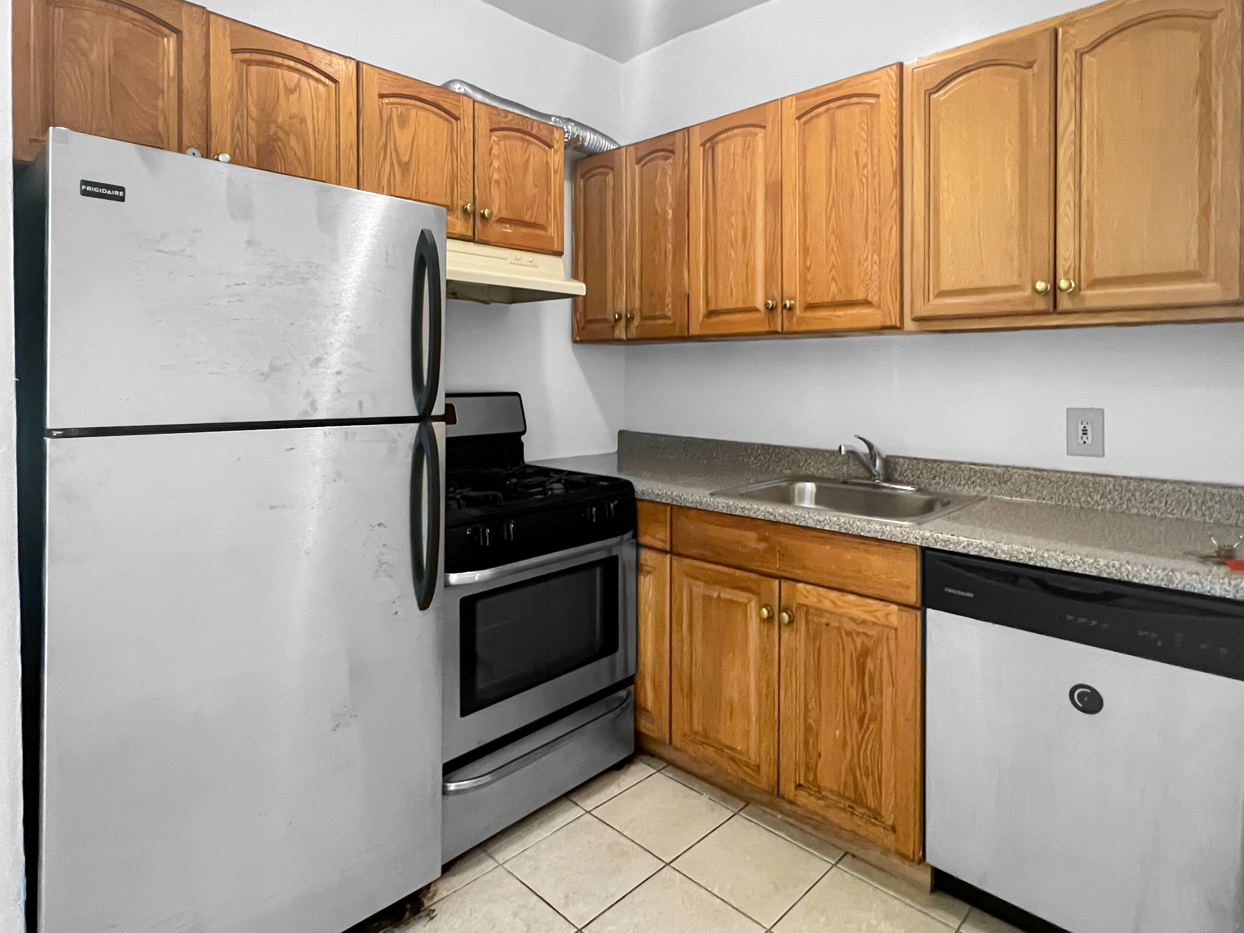 35-19 Broadway, Unit 3 Queens, NY 11106 - Photo 9 of 11 a white refrigerator freezer sitting in a kitchen