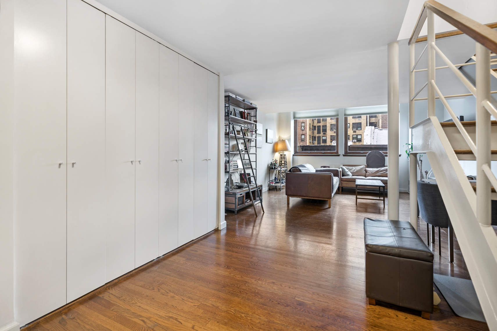 305 2nd Avenue, Unit 518 Manhattan, NY 10003 - Photo 8 of 19 a living room with furniture and a wooden floor