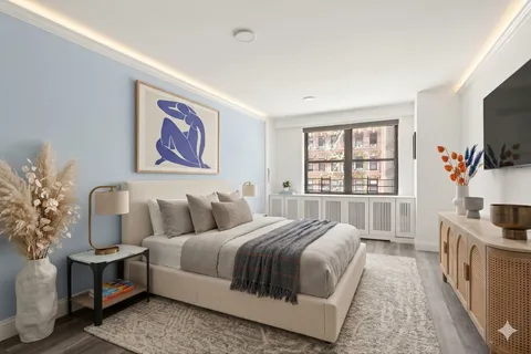 a spacious bedroom with a bed and a flat screen tv