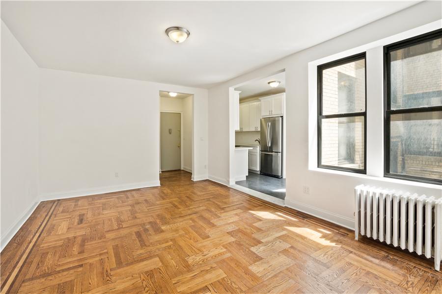 61-09 39th Avenue, Unit 2H Queens, NY 11377 - Photo 3 of 9 a view of an empty room with a window