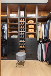 a view of walk in closet with clothes