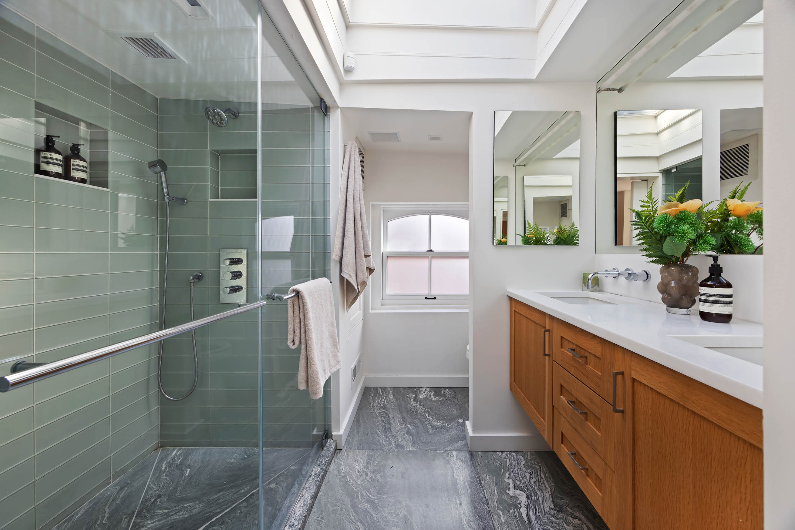 148 Warren Street Brooklyn, NY 11201 - Photo 17 of 20 a spacious bathroom with a double vanity sink a large mirror and a shower