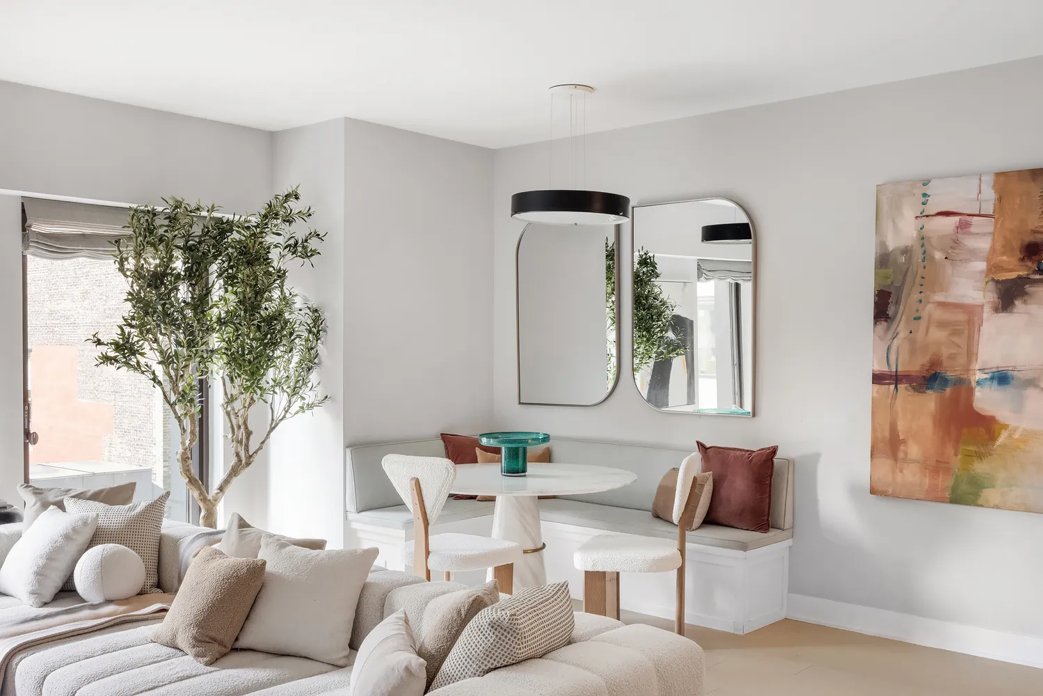 a living room with furniture and a potted plant