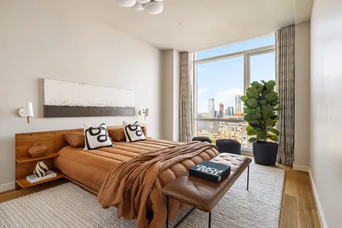 a bedroom with a bed and a couch