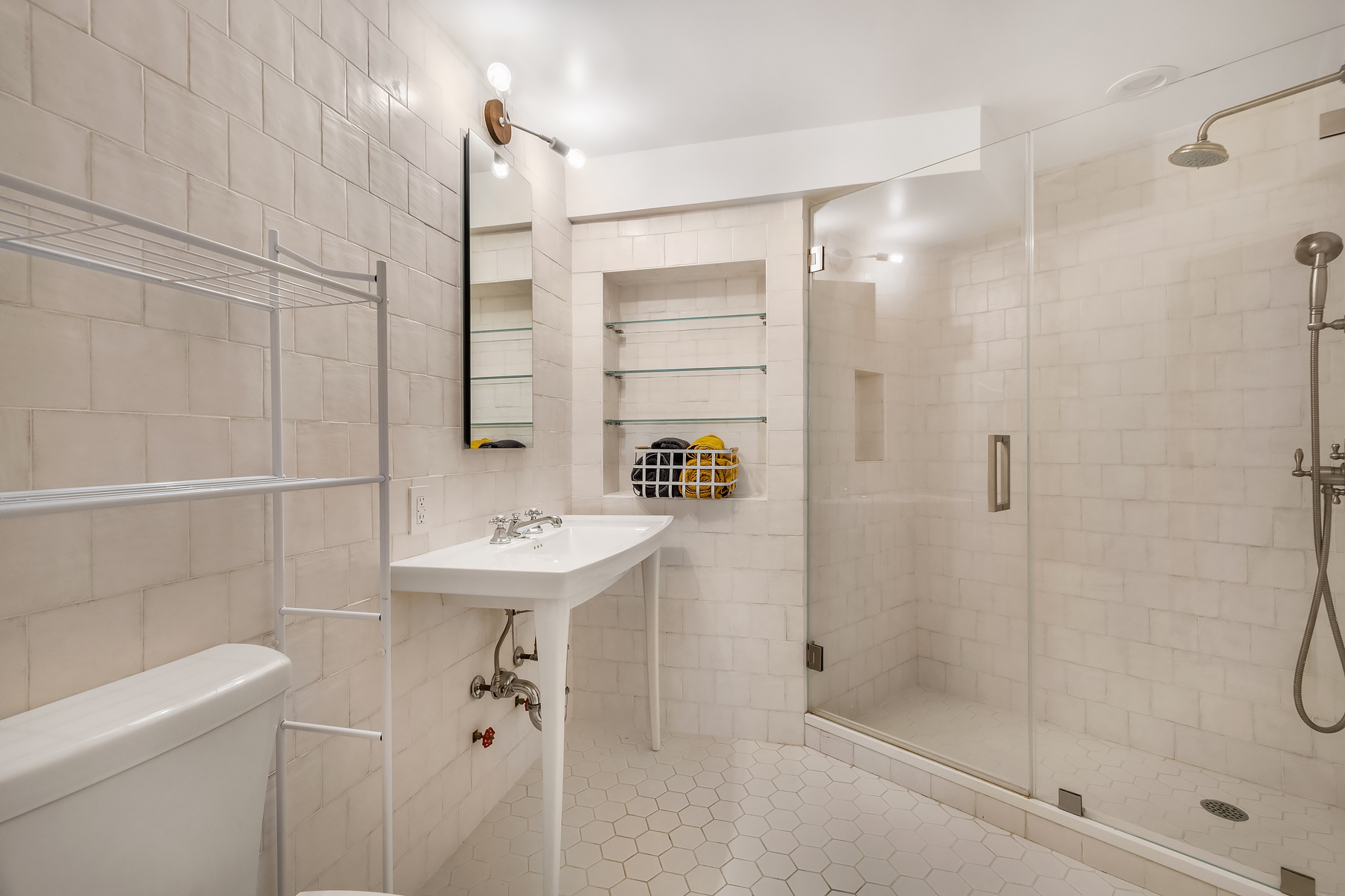 163 St Nicholas Avenue, Unit PH7A Manhattan, NY 10026 - Photo 7 of 11 a bathroom with a sink a toilet and shower