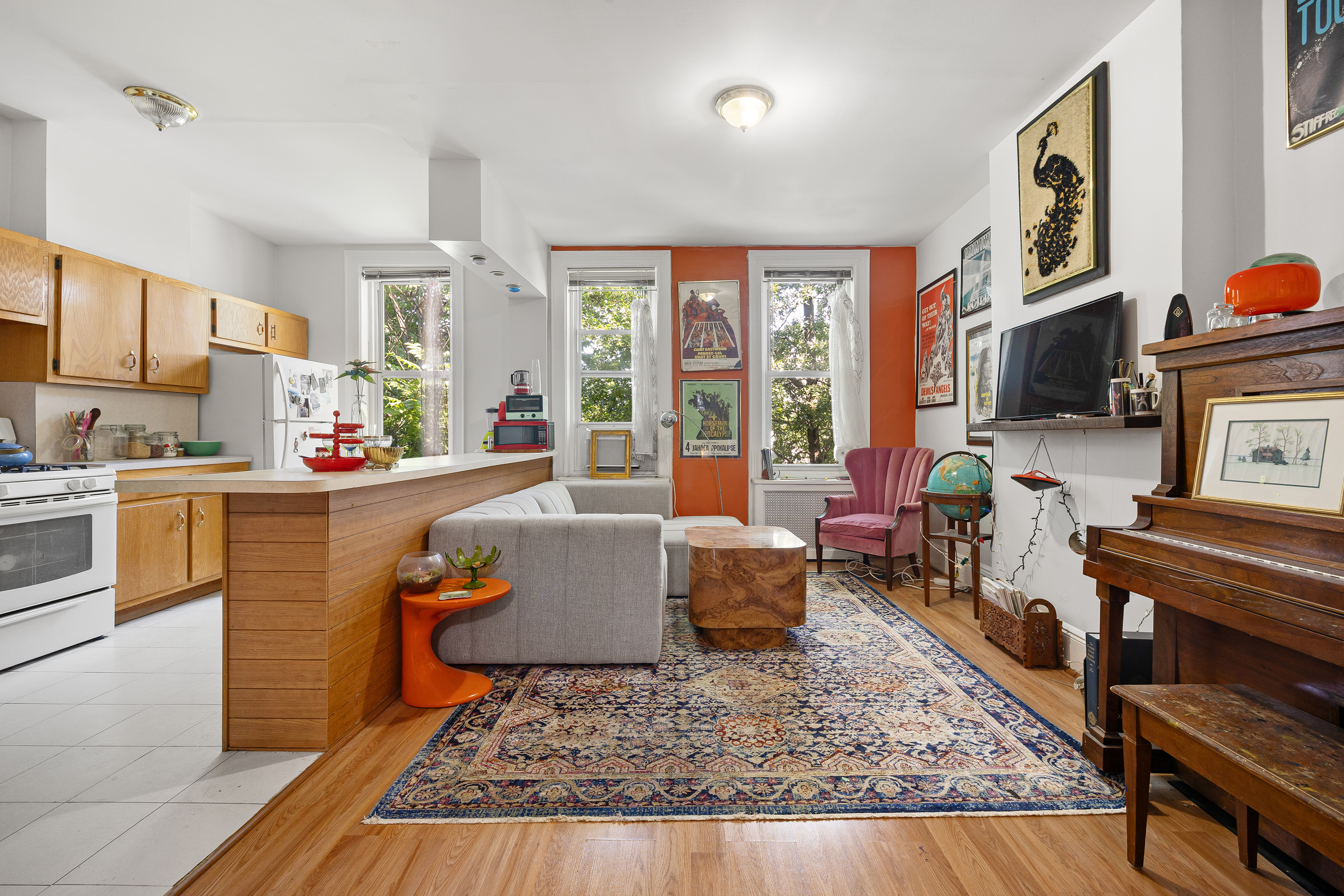 59-47 Madison Street, Unit 2 Queens, NY 11385 - Photo 1 of 12 a living room with furniture fireplace and a table