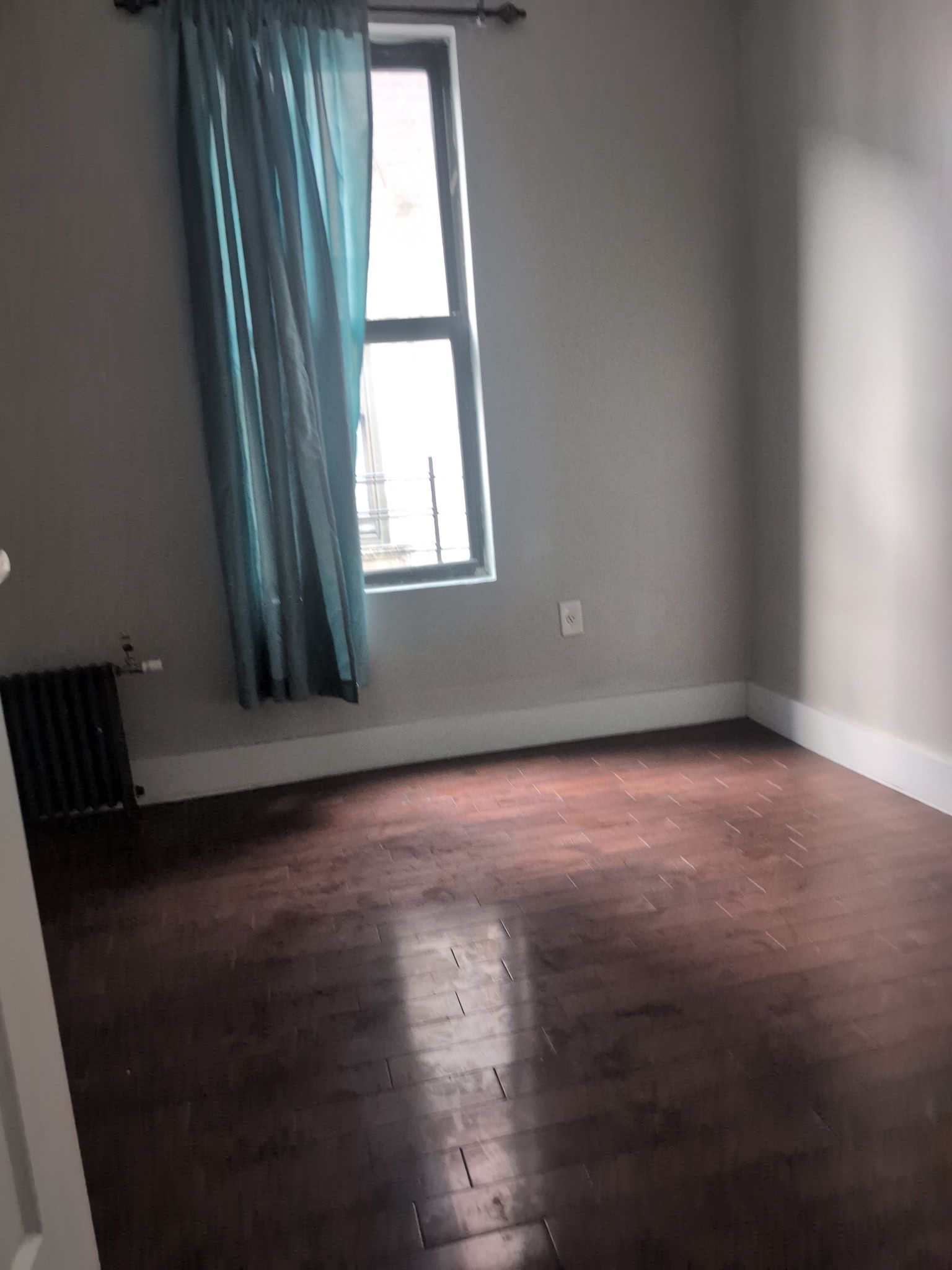 2405 Nostrand Avenue, Unit 6 Brooklyn, NY 11210 - Photo 8 of 11 an empty room with wooden floor and windows