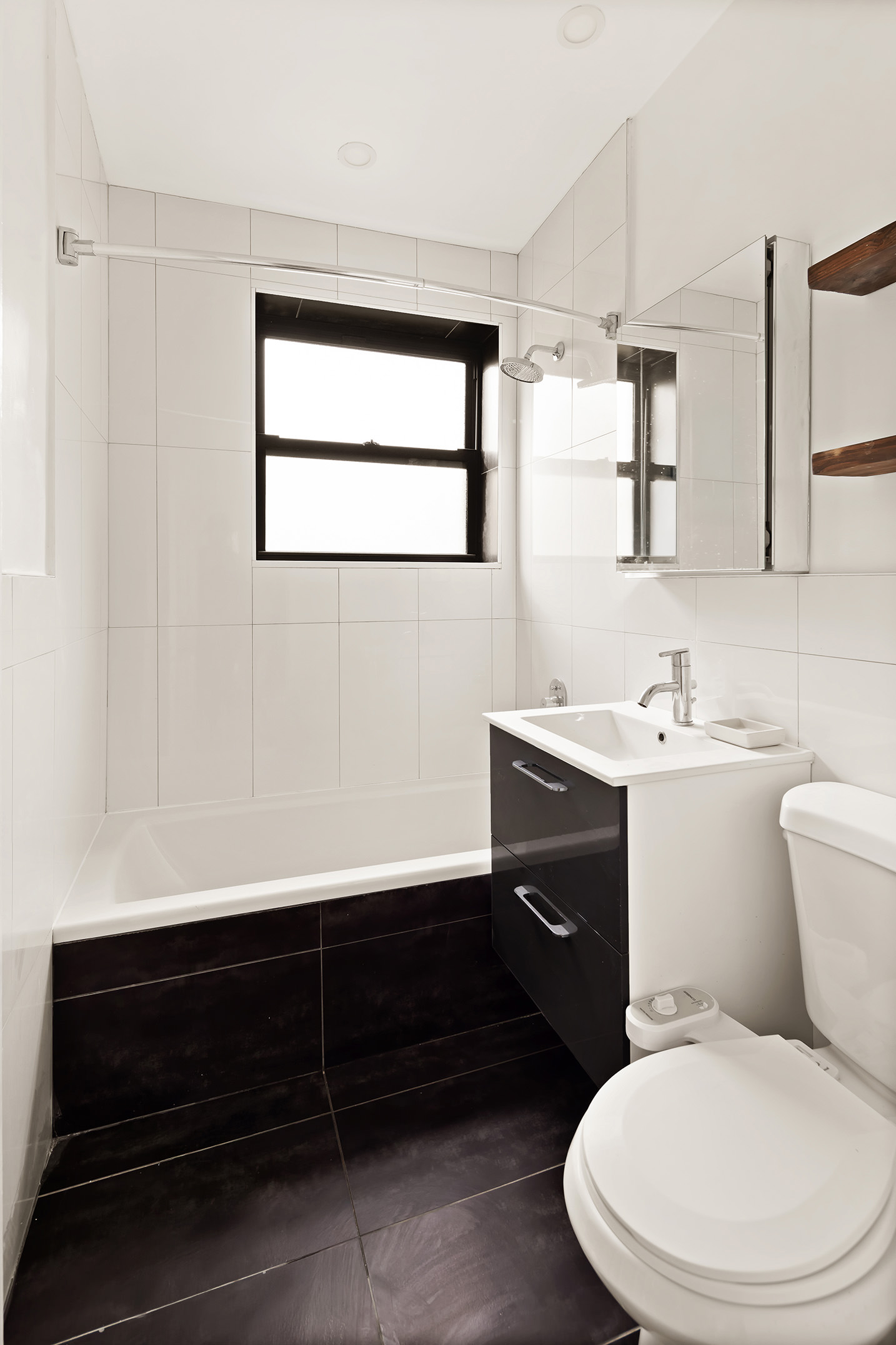 106 Monroe Street, Unit 2 Brooklyn, NY 11216 - Photo 5 of 6 a bathroom with a toilet sink and mirror