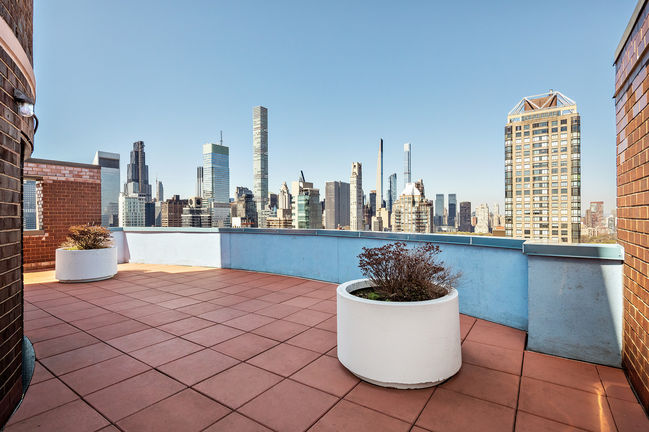 304 East 65th Street, Unit 10D Manhattan, NY 10065 - Photo 11 of 14 a view of a terrace with chairs and a potted plant