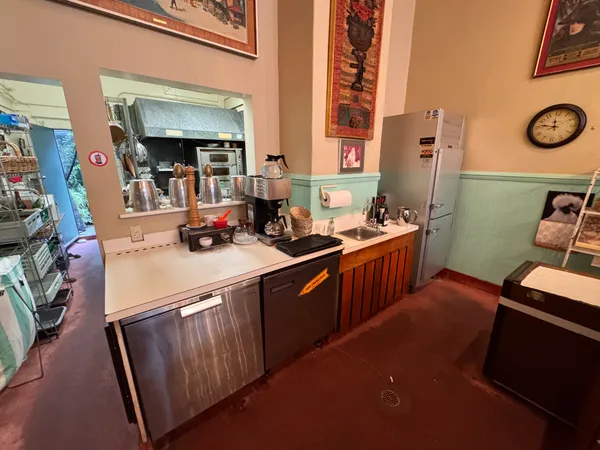 a kitchen with stainless steel appliances granite countertop a sink a stove and a refrigerator