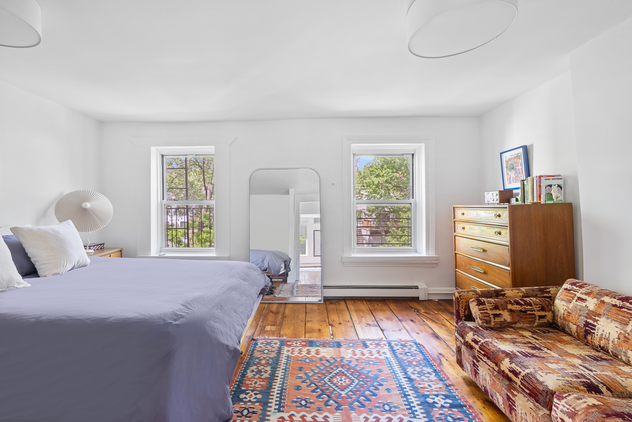 437 Warren Street Brooklyn, NY 11217 - Photo 10 of 17 a bedroom with a bed and two windows