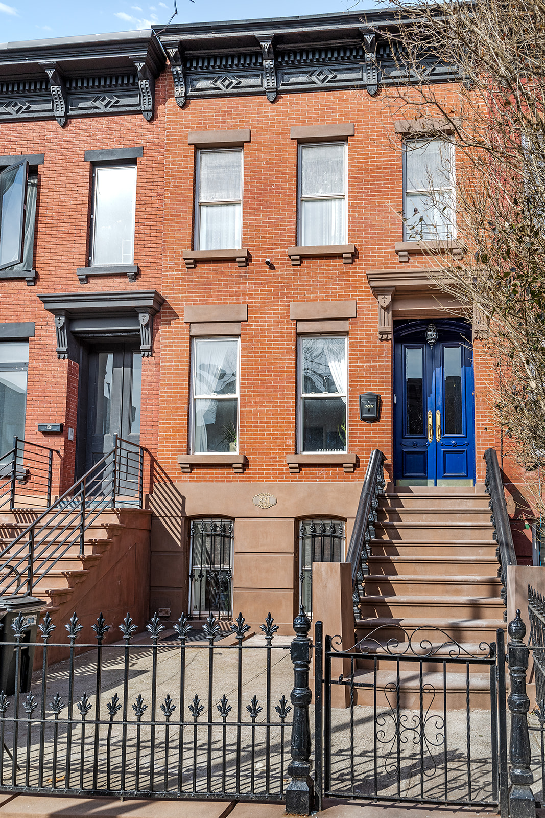 231 Vernon Avenue Brooklyn, NY 11206 - Photo 12 of 13 a front view of a house with a fence