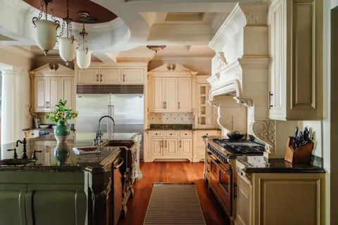 a kitchen with stainless steel appliances granite countertop a stove a sink dishwasher and cabinets with wooden floor