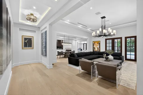 a living room with furniture chandelier and a chandelier