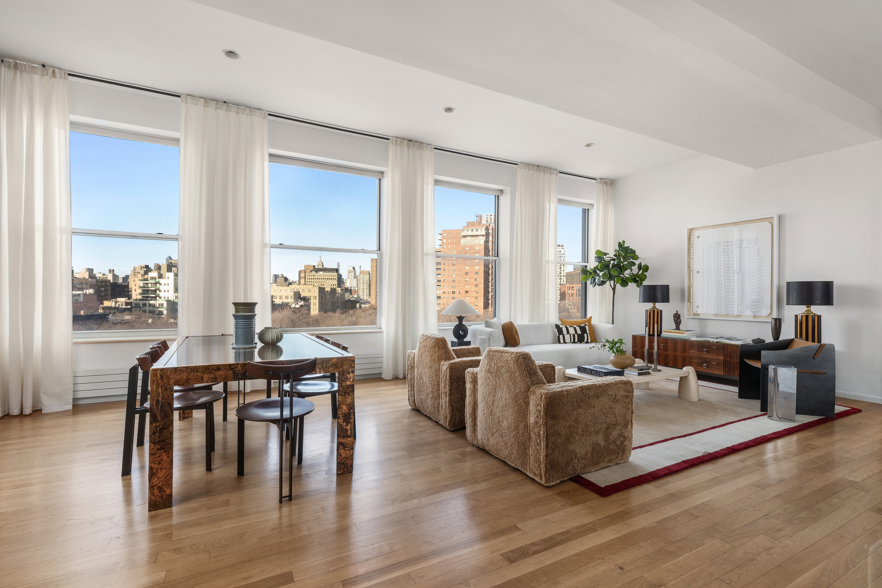 175 East Broadway, Unit 7A Manhattan, NY 10002 - Photo 3 of 24 a living room with furniture wooden floor and a large window