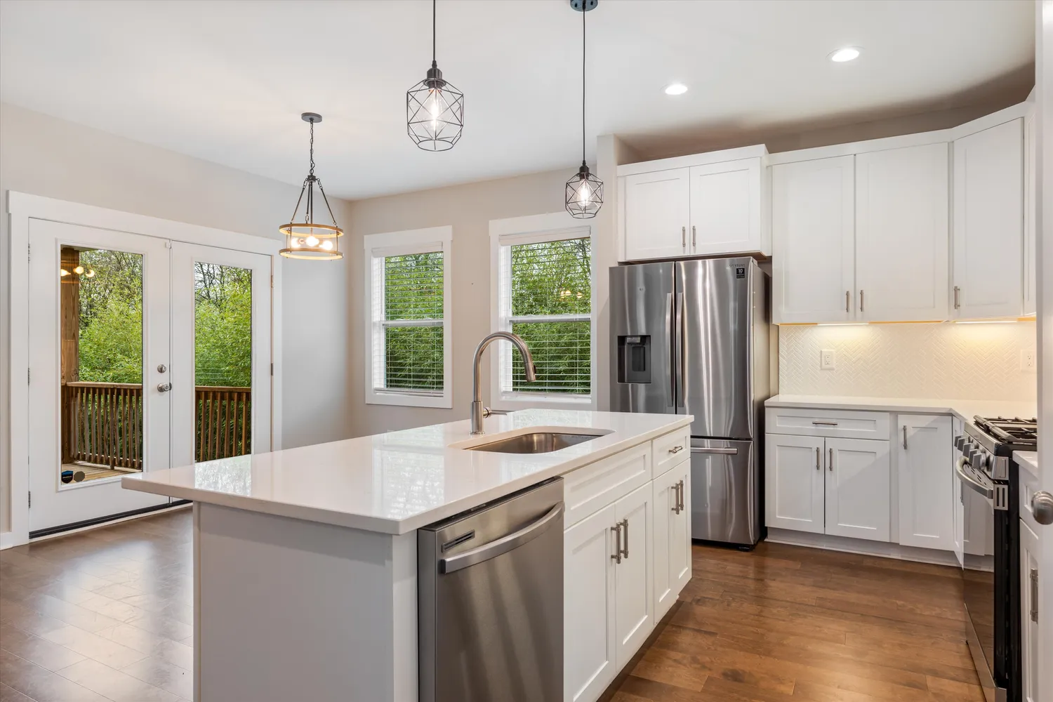 a kitchen with a refrigerator a sink and a stove