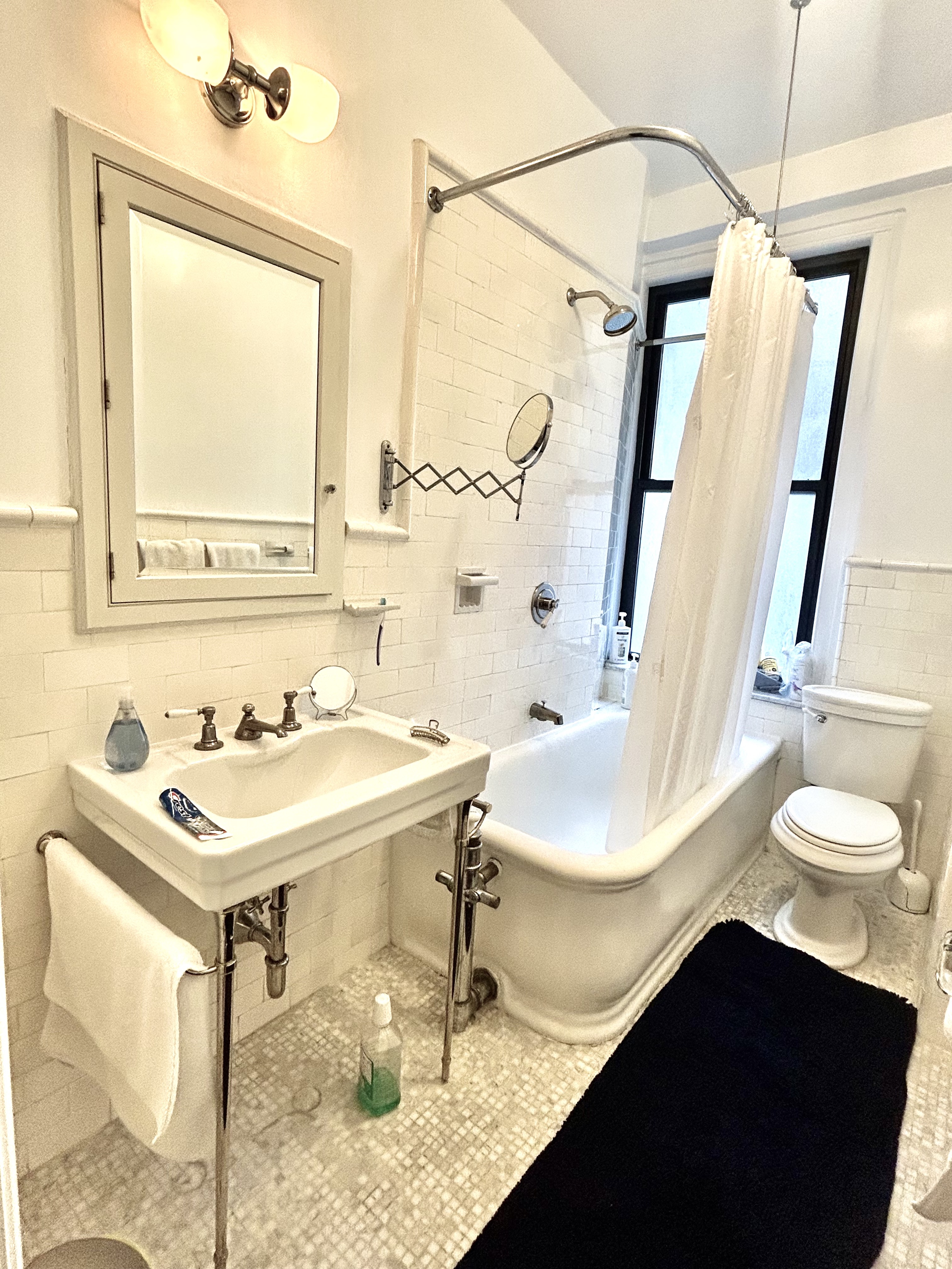 200 West 54th Street, Unit 6D Manhattan, NY 10019 - Photo 4 of 6 a bathroom with a sink vanity and a mirror