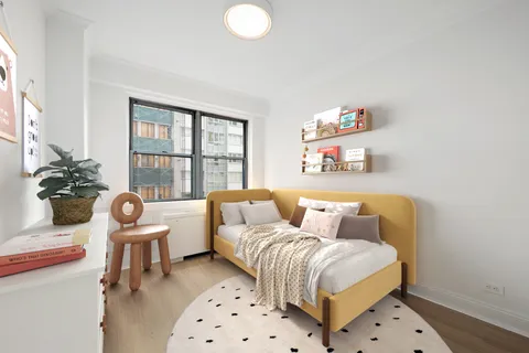 a bedroom with furniture and a window