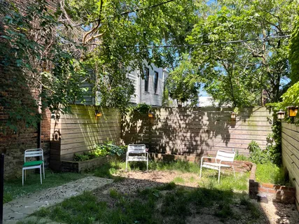 a backyard of a house with table and chairs