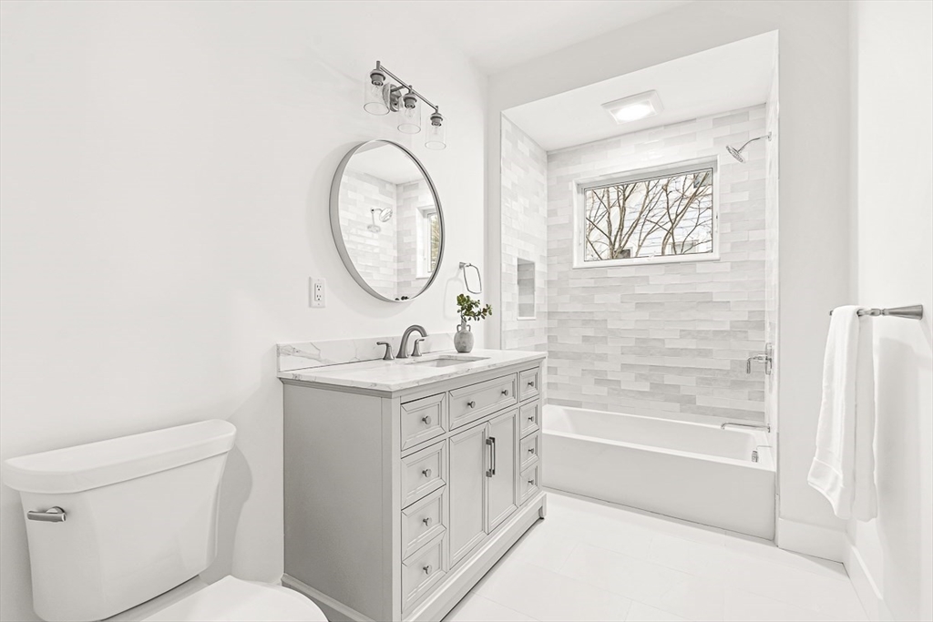 6 Intervale Road Wellesley, MA 02481 - Photo 27 of 33 a bathroom with a granite countertop toilet a sink and a bathtub