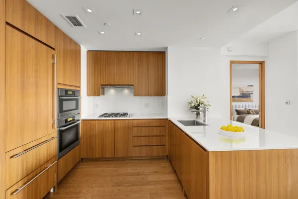 a large kitchen with stainless steel appliances granite countertop a sink and cabinets