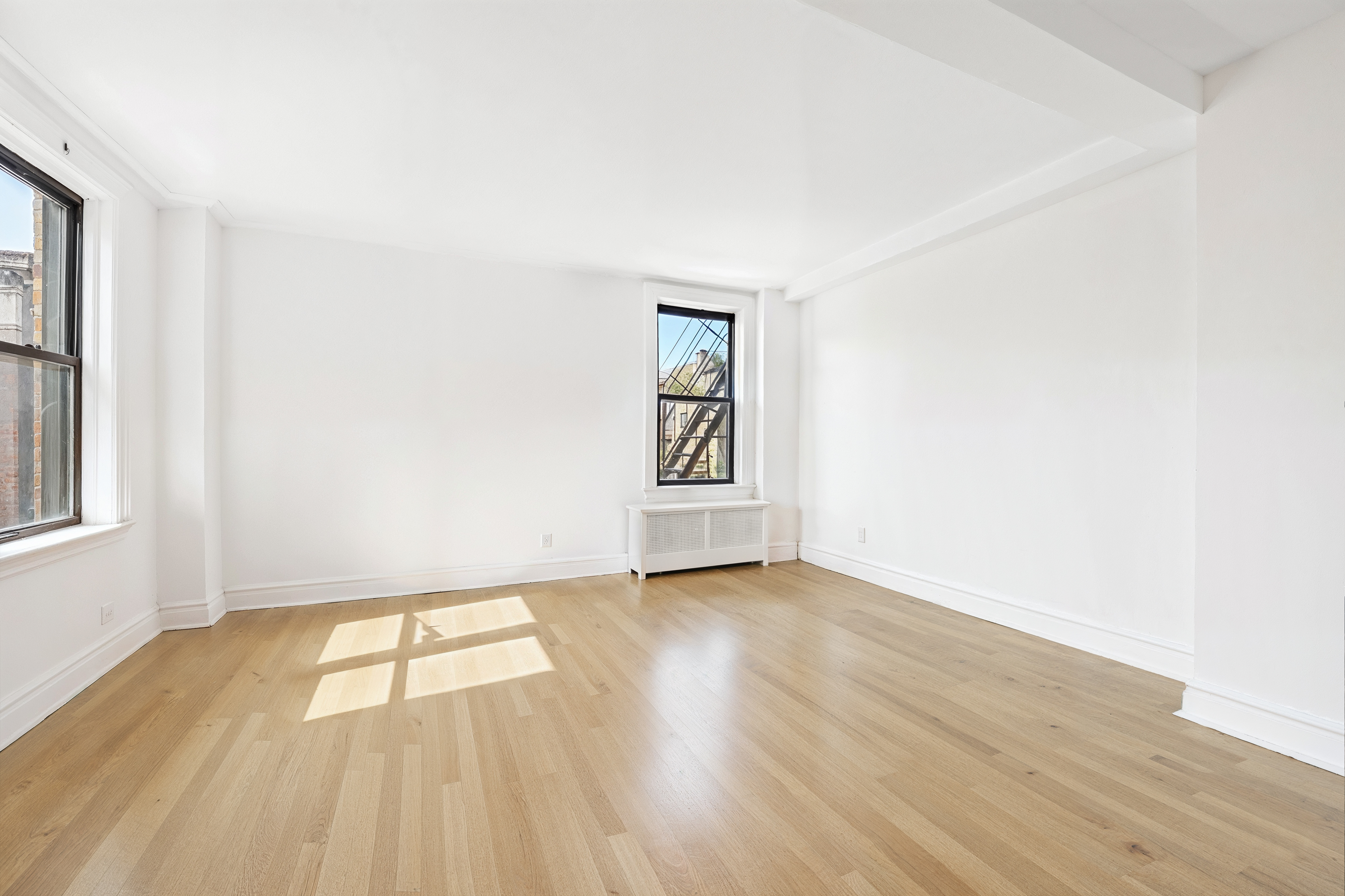 473 West End Avenue, Unit 13D Manhattan, NY 10024 - Photo 4 of 13 an empty room with wooden floor and windows