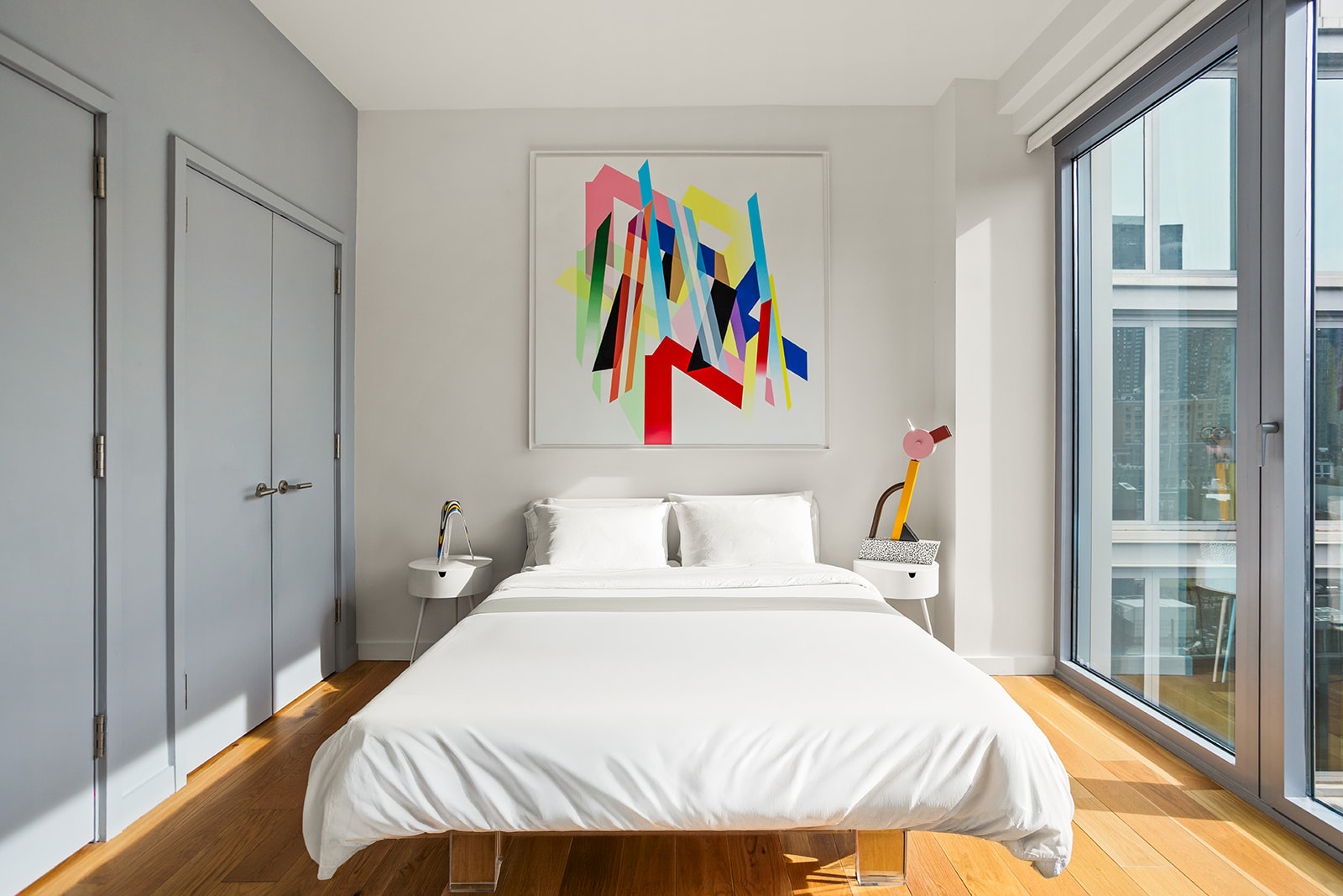 547 West 47th Street, Unit 1102 Manhattan, NY 10036 - Photo 6 of 19 a bedroom with a bed and painting on the wall