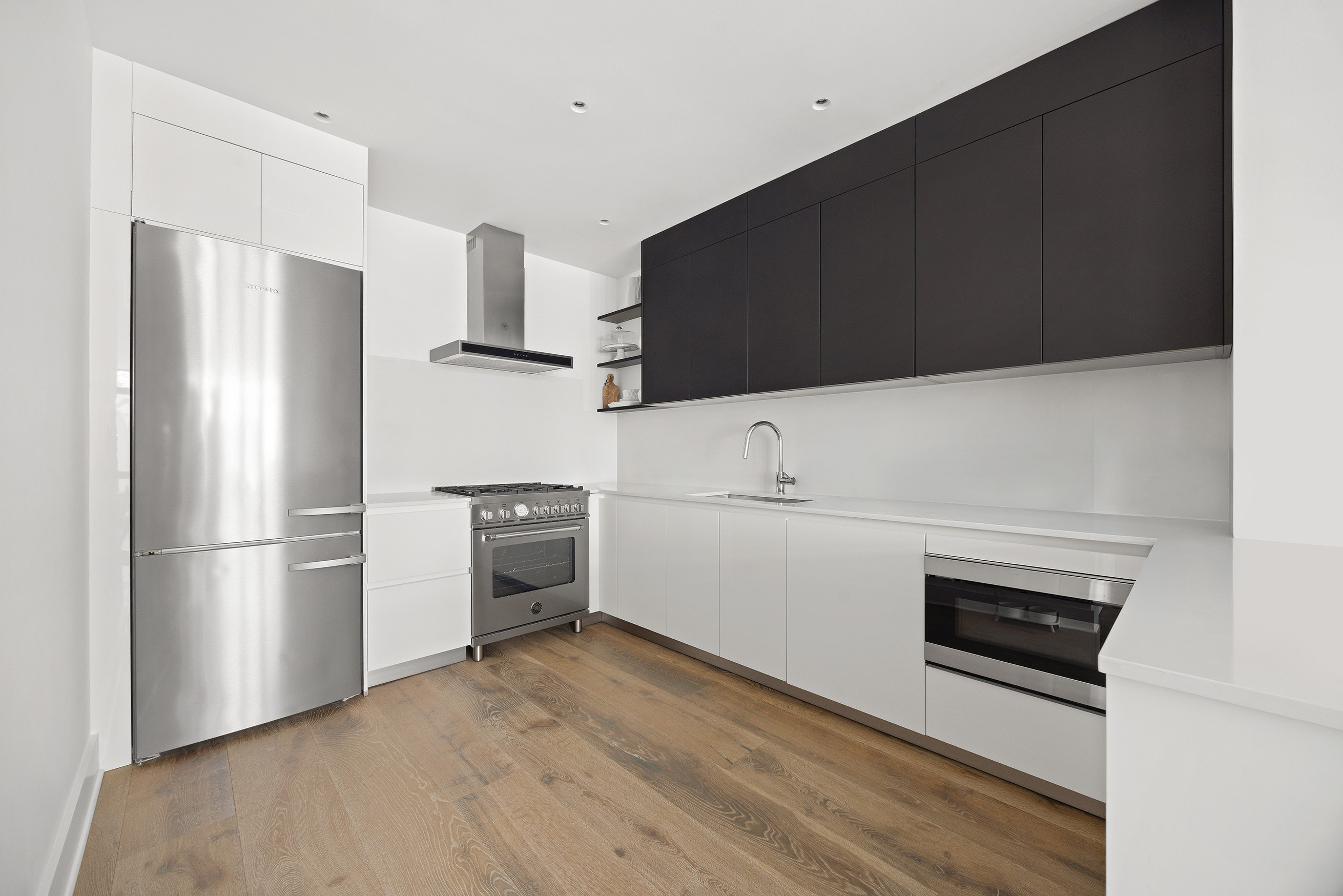 128 West 26th Street, Unit PH Manhattan, NY 10001 - Photo 10 of 21 a kitchen with a refrigerator and a stove