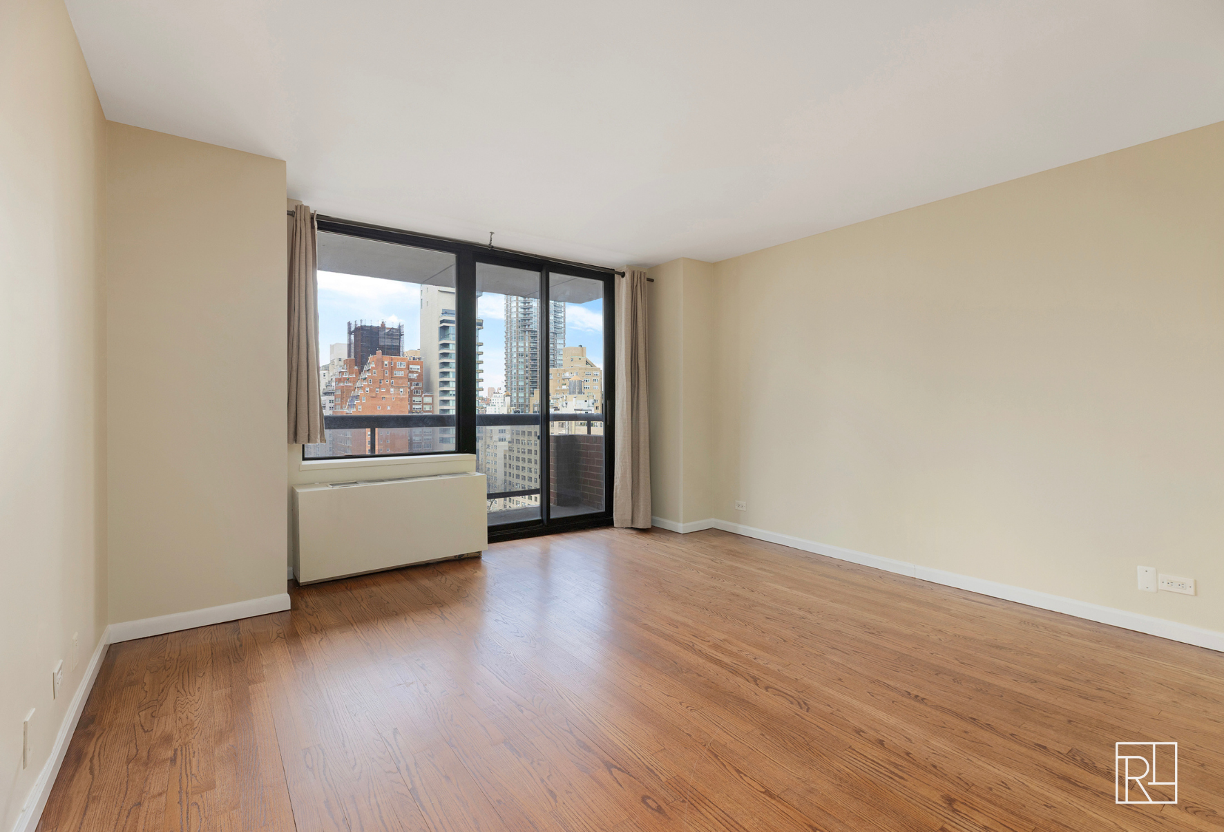 300 East 62nd Street, Unit 1501 Manhattan, NY 10065 - Photo 3 of 14 a view of a room with wooden floor and a window