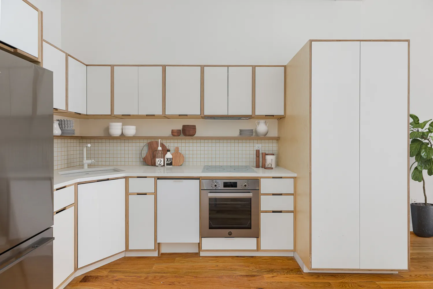 a kitchen with stainless steel appliances granite countertop a stove a sink and white cabinets