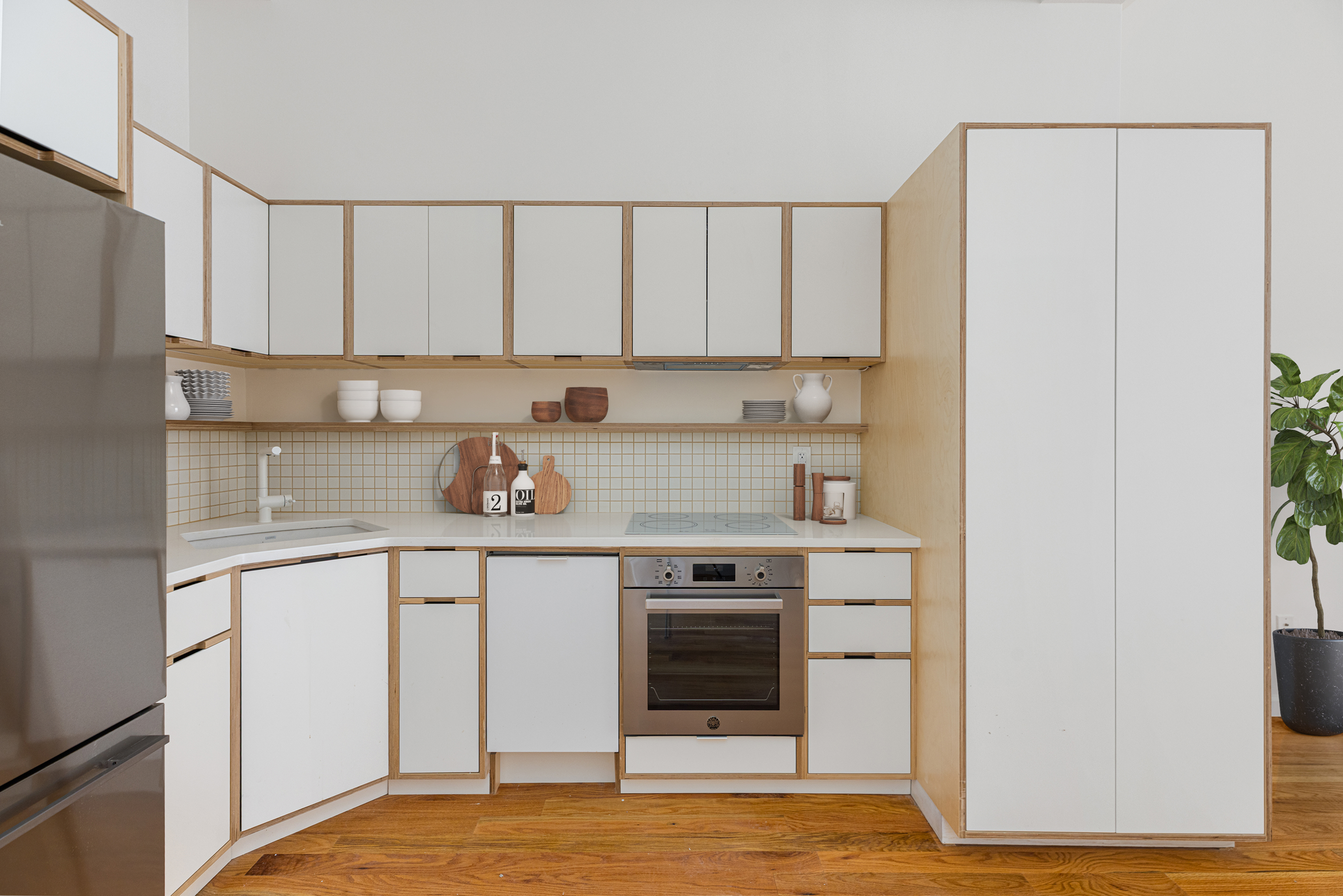 1068 Hancock Street, Unit 1 Brooklyn, NY 11221 - Photo 3 of 11 a kitchen with stainless steel appliances granite countertop a stove a sink and white cabinets
