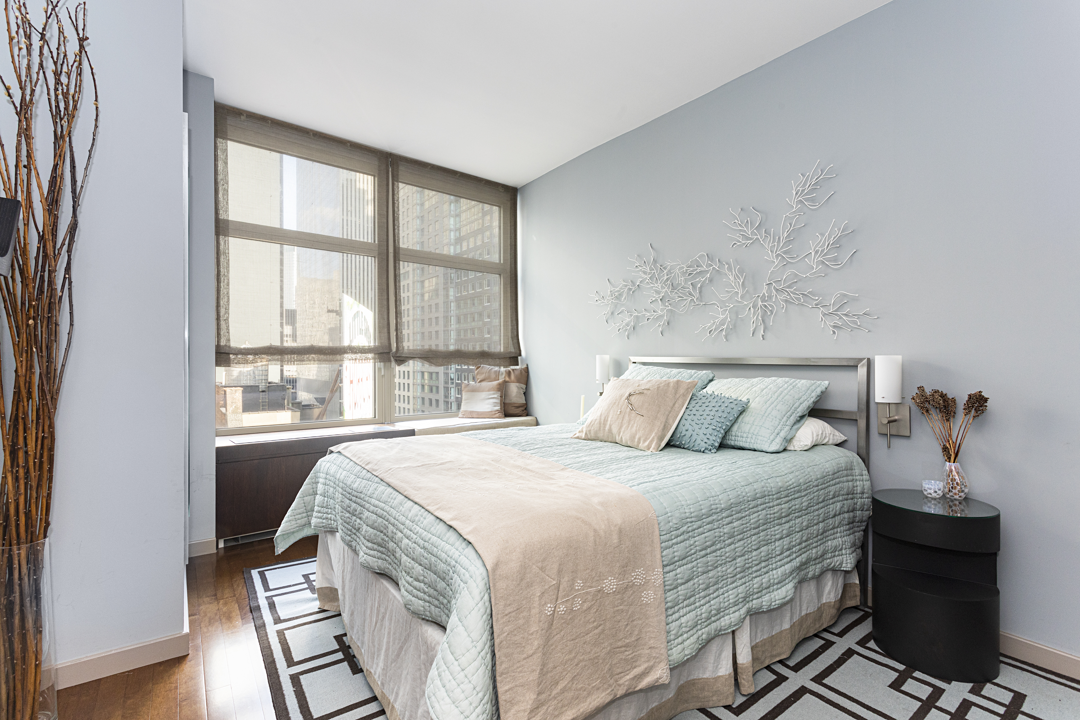 1600 Broadway, Unit 18G Manhattan, NY 10019 - Photo 6 of 10 a bedroom with a bed and a window