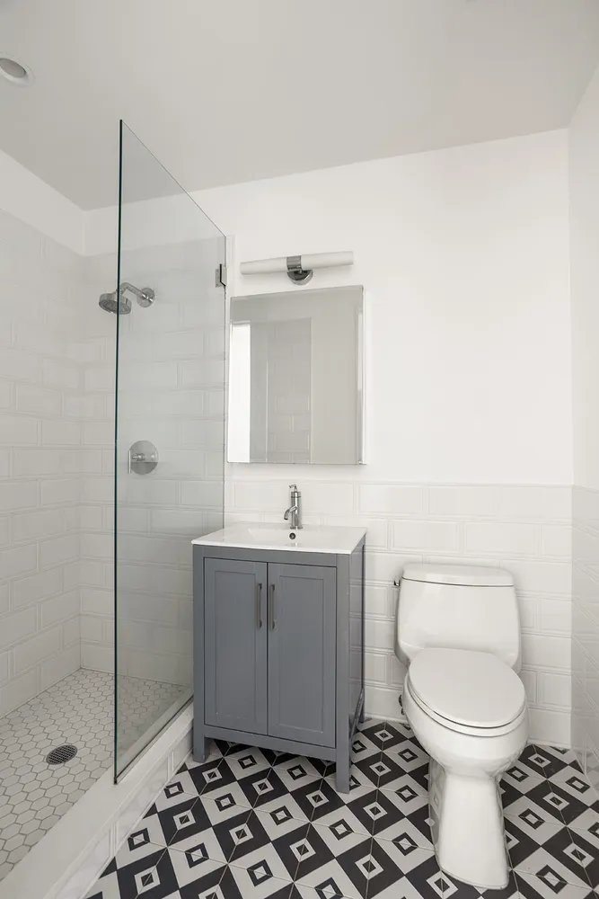 a bathroom with a toilet a sink and shower
