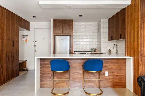 a kitchen with stainless steel appliances granite countertop a sink and a refrigerator