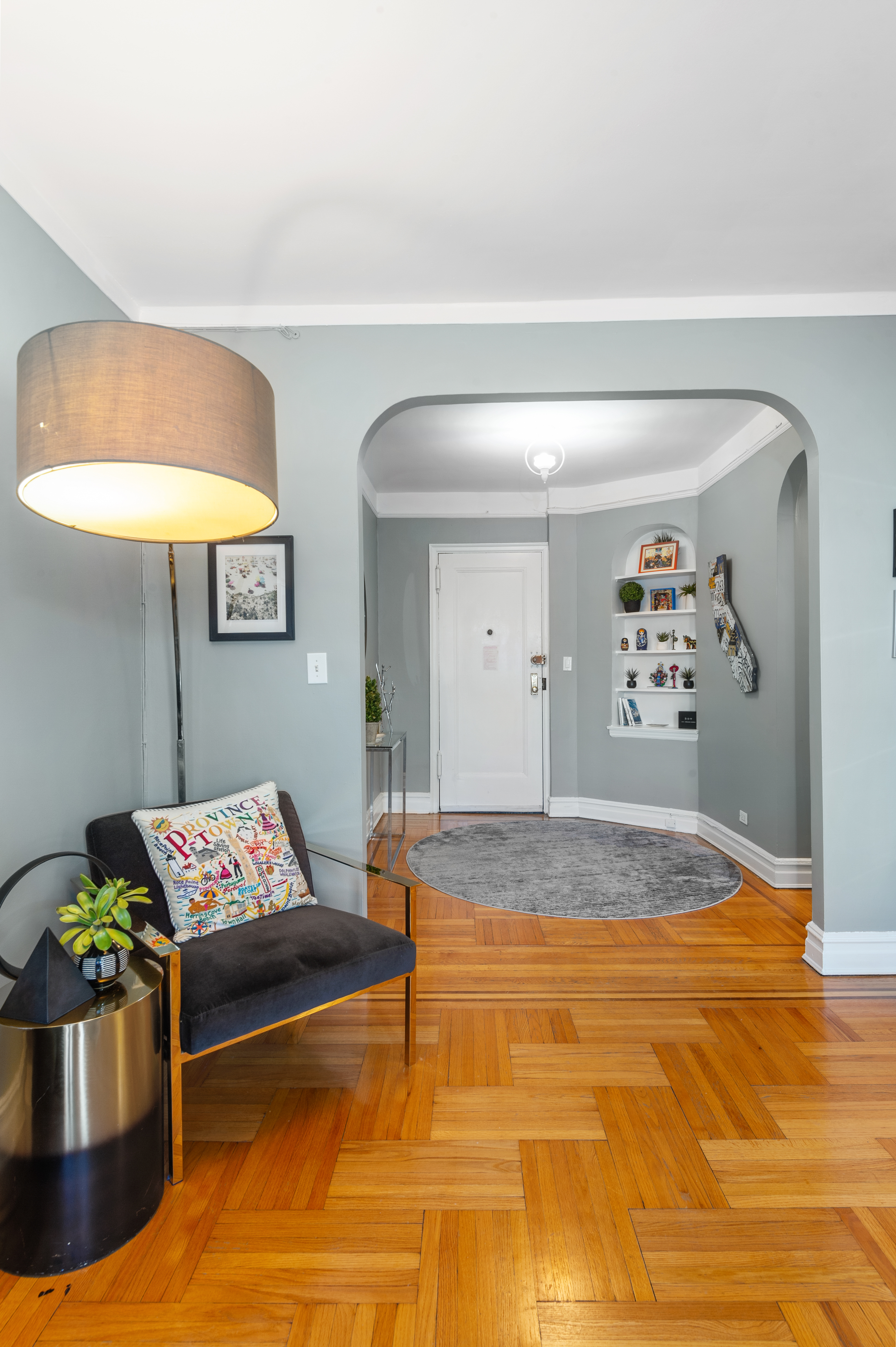 35-06 88th Street, Unit 6B Queens, NY 11372 - Photo 3 of 9 a living room with a couch and potted plant