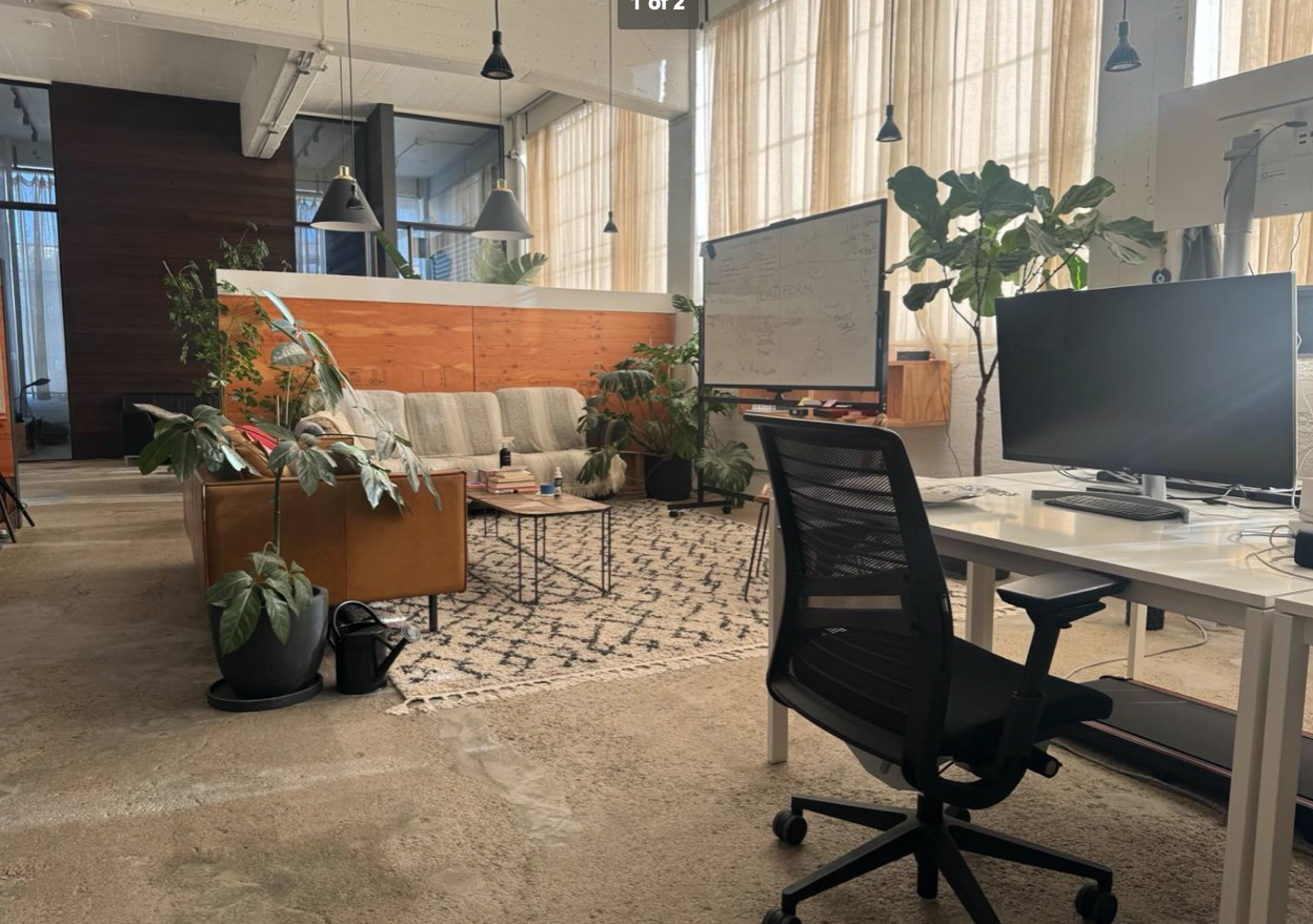 a view of a dining room with furniture and a window