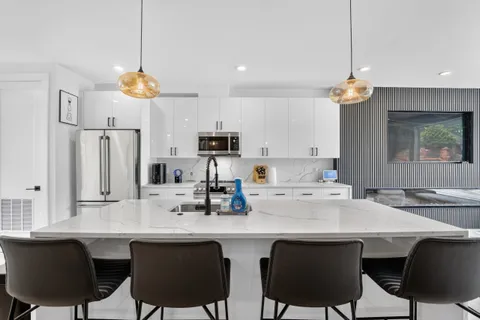 a kitchen with cabinets a center island and appliances