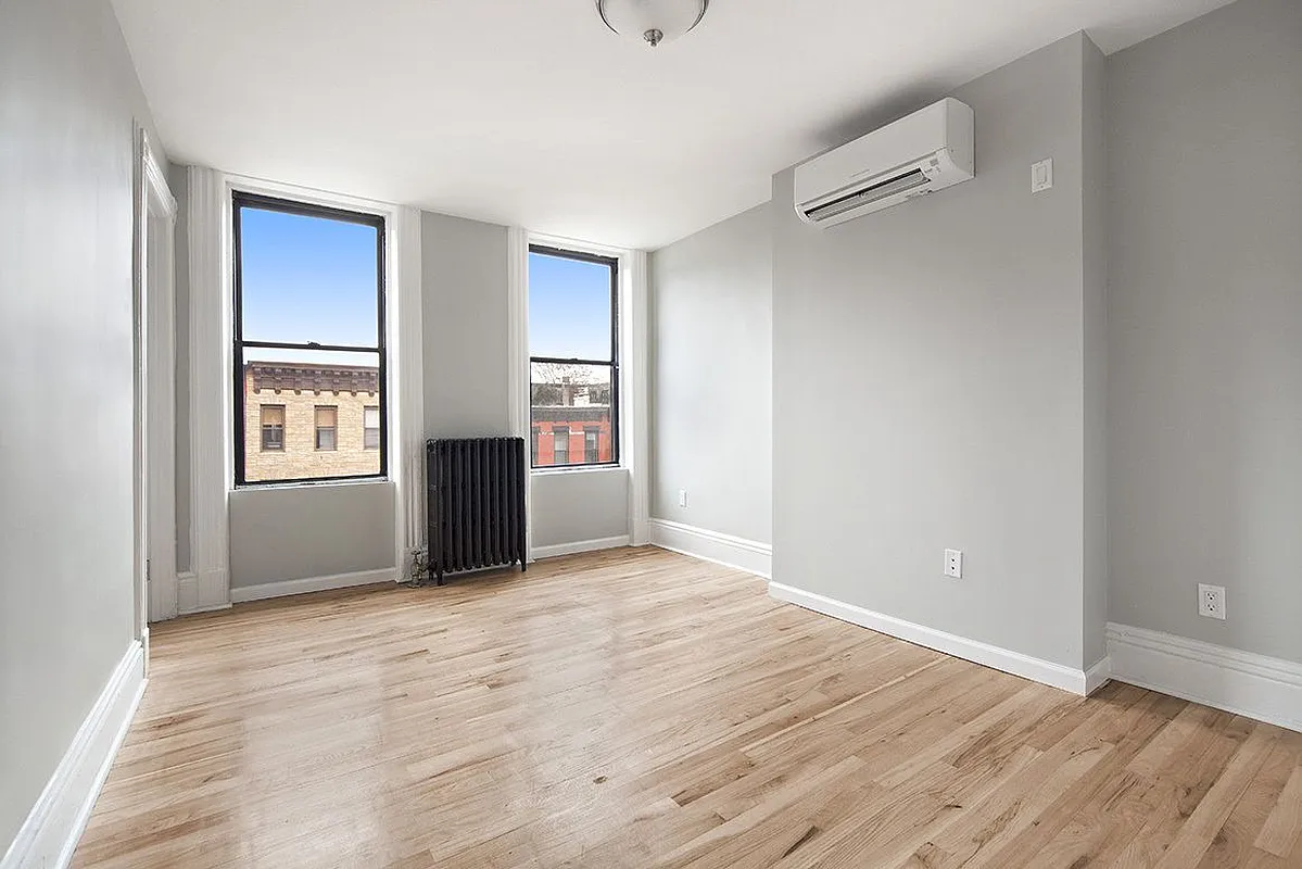 306 7th Street, Unit 1 Brooklyn, NY 11215 - Photo 6 of 9 a view of an empty room with window and wooden floor