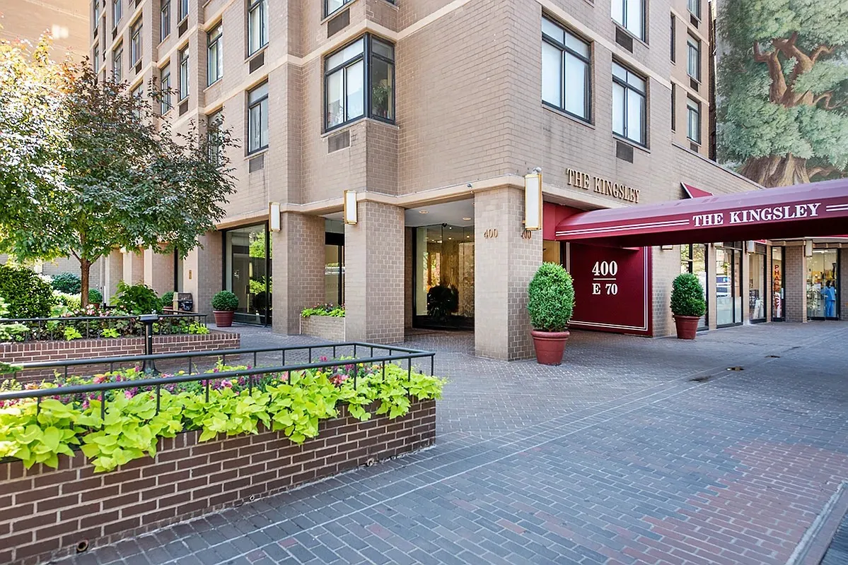 a front view of a building with a garden