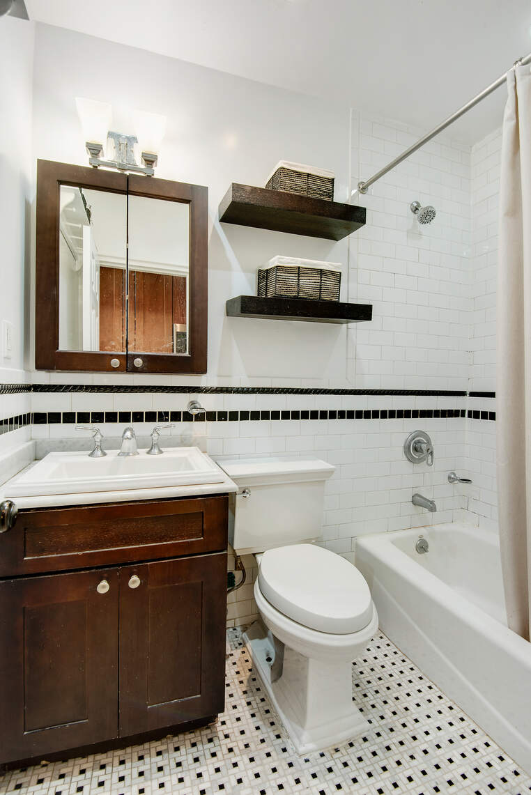 310 West 98th Street, Unit 1B Manhattan, NY 10025 - Photo 8 of 11 a bathroom with a sink a toilet and a mirror
