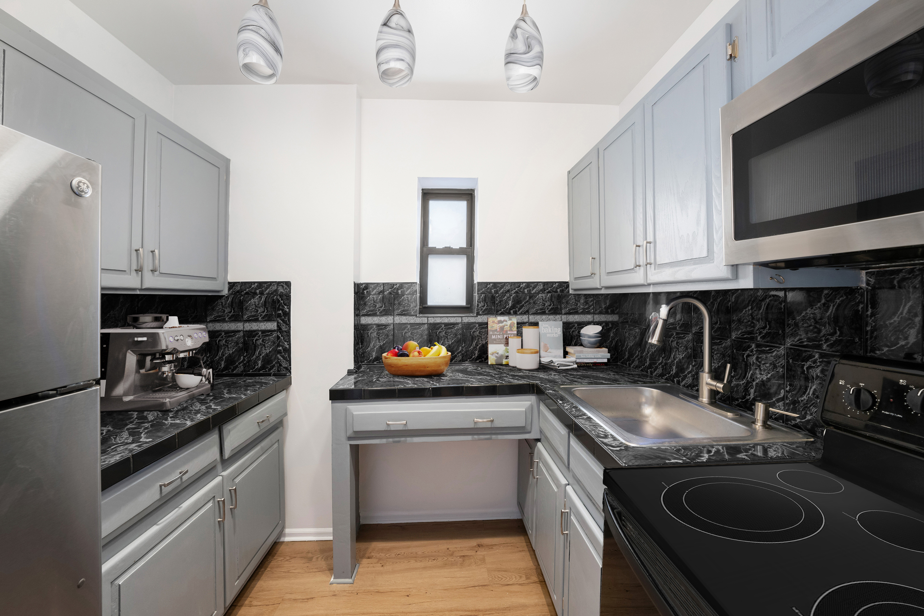 430 Sterling Place, Unit 2B Brooklyn, NY 11238 - Photo 5 of 14 a kitchen with stainless steel appliances granite countertop a sink stove top oven and cabinets