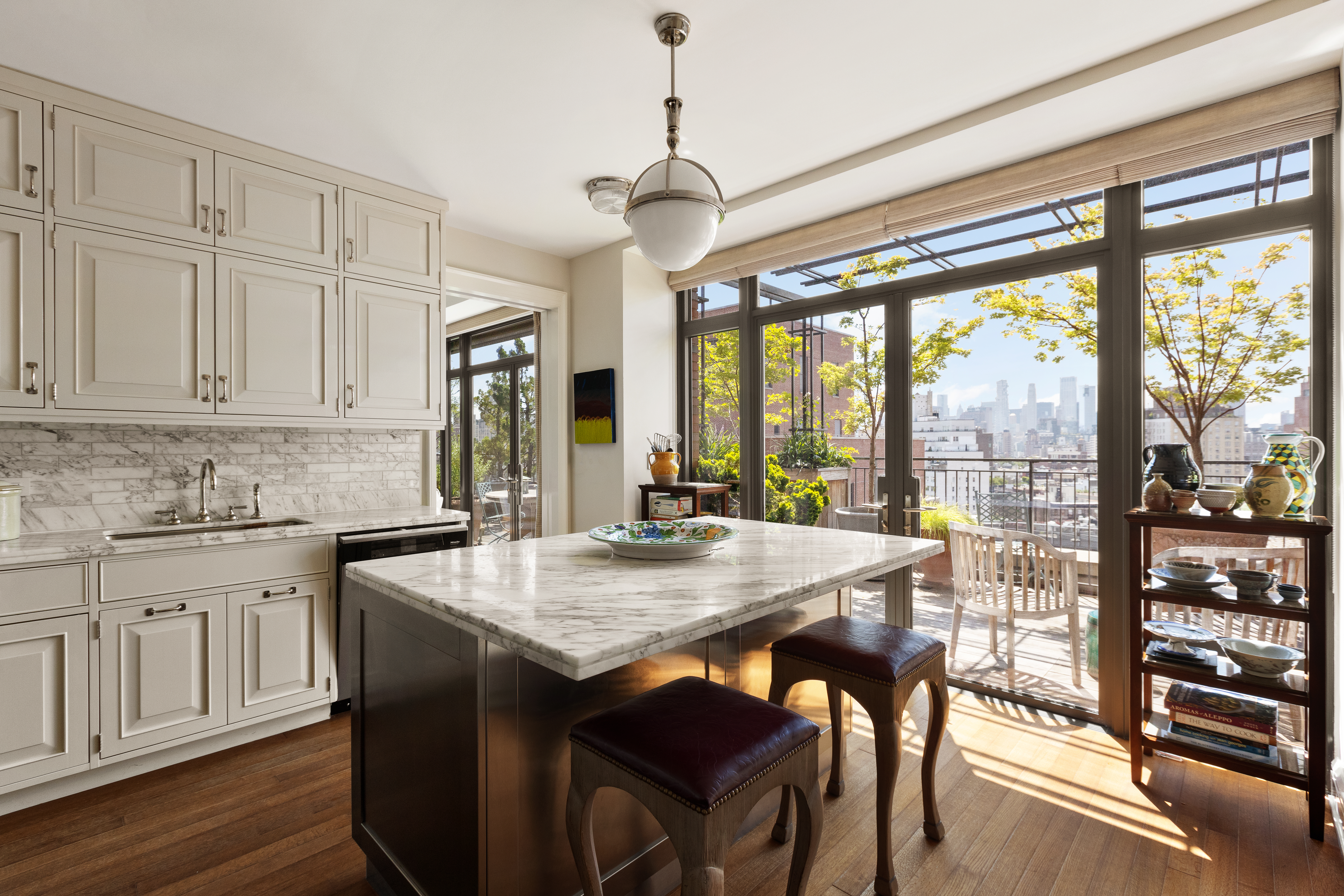 160 West 12th Street, Unit 104 Manhattan, NY 10011 - Photo 5 of 28 a kitchen with stainless steel appliances granite countertop a stove and white cabinets
