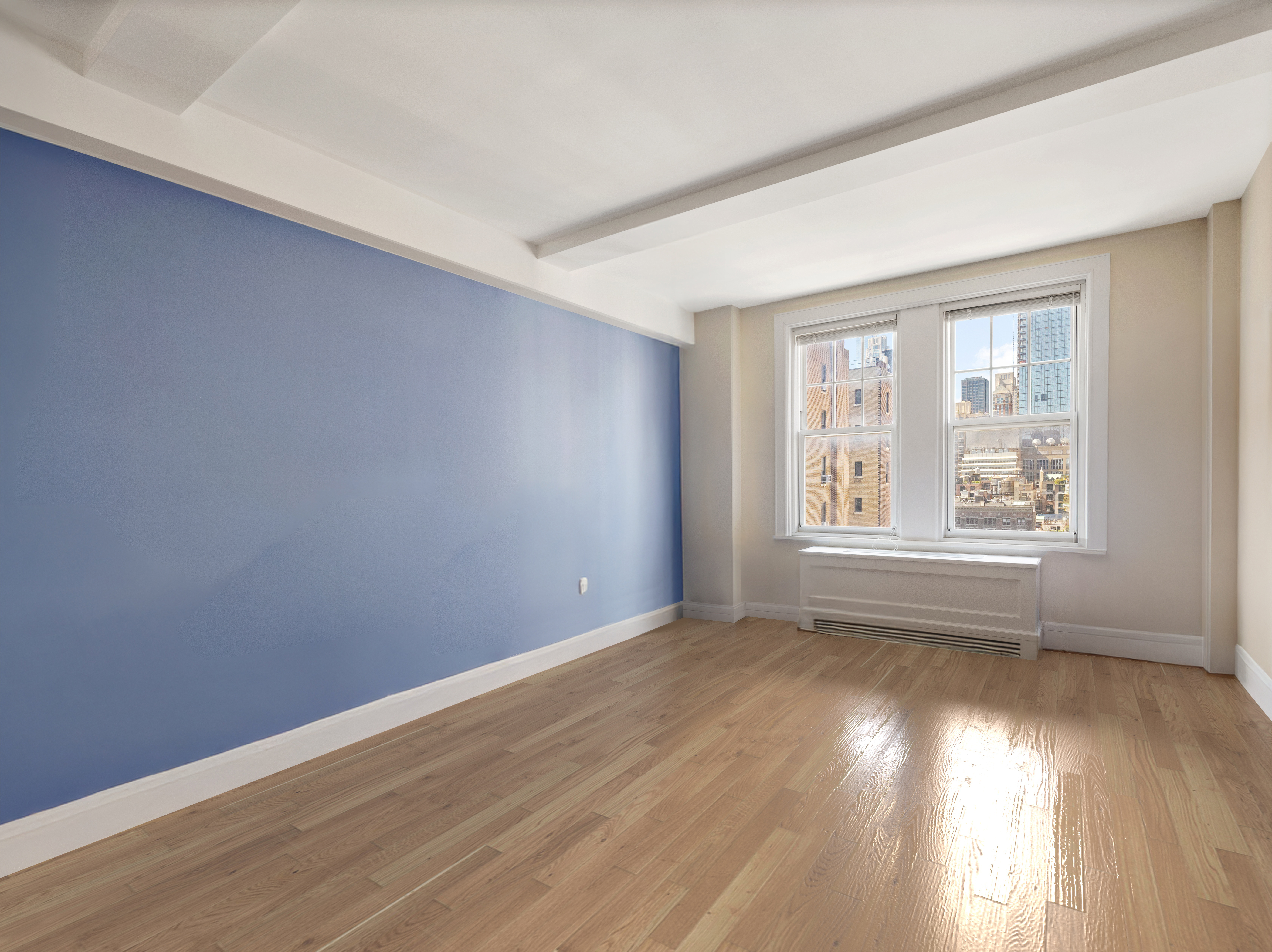 27 West 72nd Street, Unit 1403 Manhattan, NY 10023 - Photo 7 of 18 an empty room with wooden floor and windows