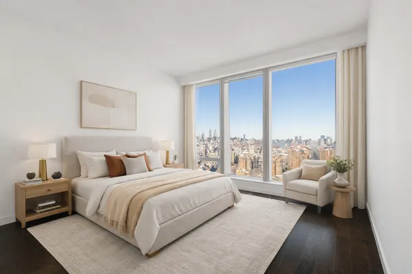 a bedroom with a bed and a couch next to a window