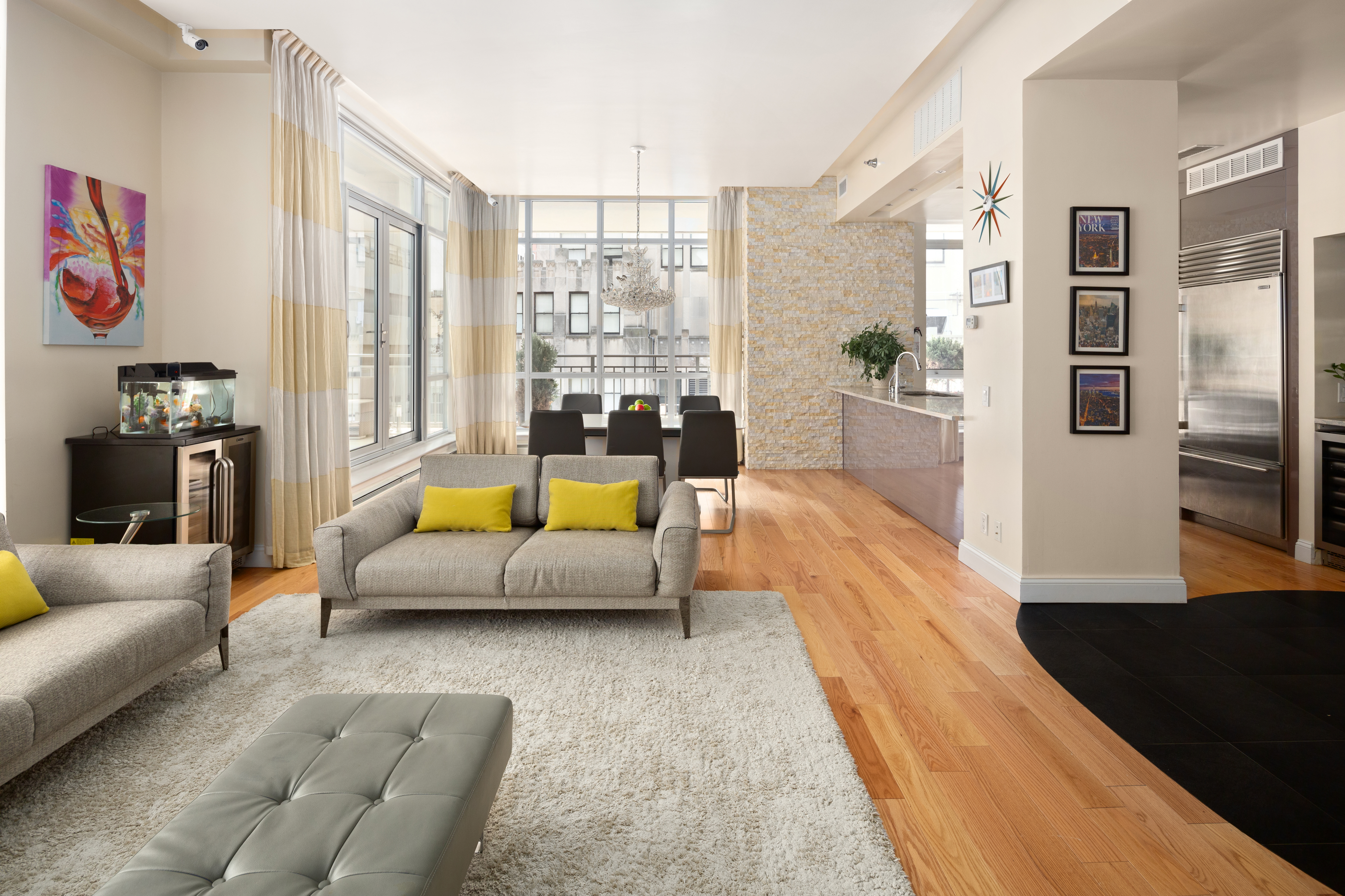 59 John Street, Unit PH1 Manhattan, NY 10038 - Photo 2 of 15 a living room with furniture and a large window
