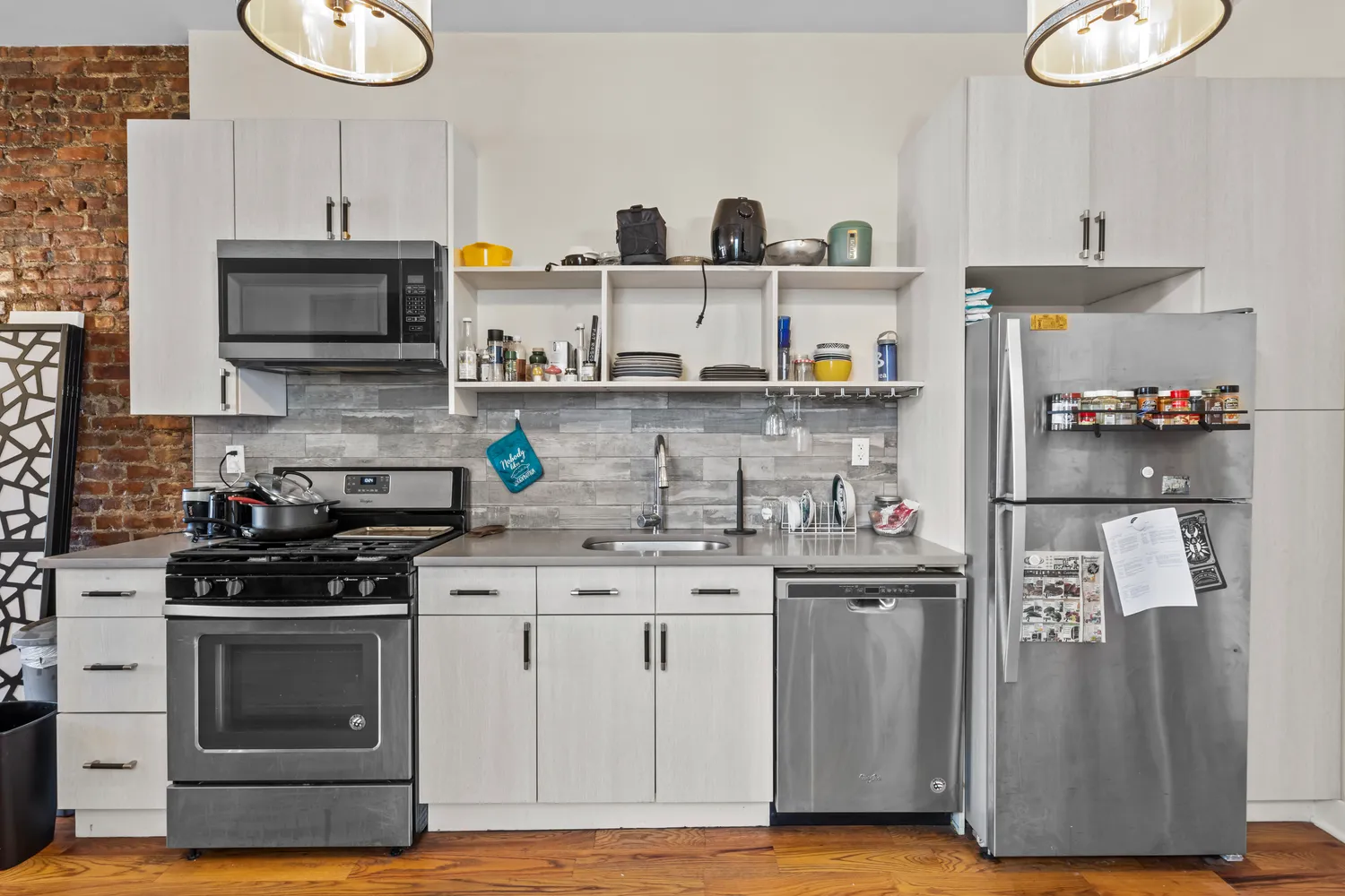a kitchen with stainless steel appliances granite countertop a stove and a refrigerator