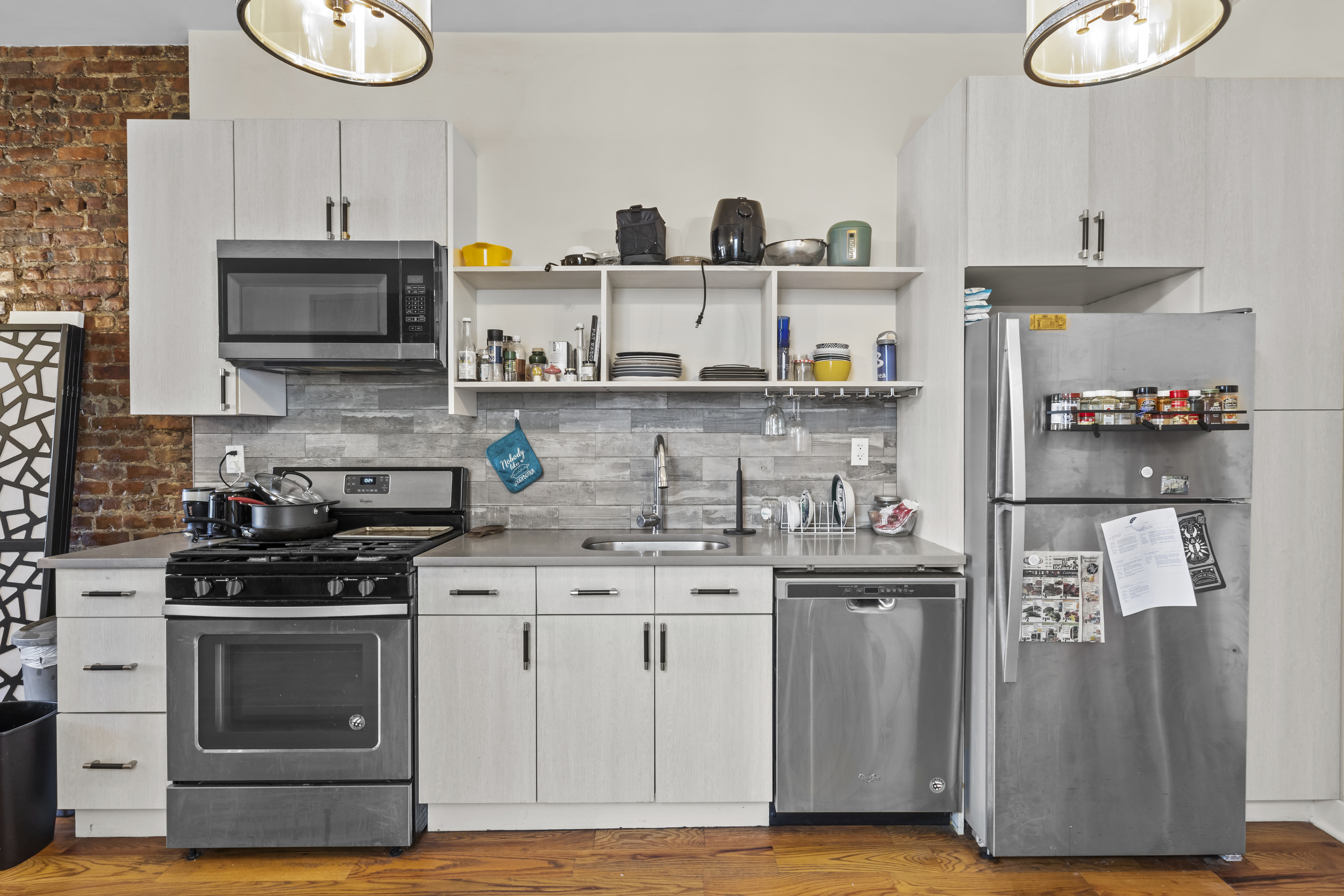 1273 Rogers Avenue, Unit MULTIFAM Brooklyn, NY 11226 - Photo 11 of 13 a kitchen with stainless steel appliances granite countertop a stove and a refrigerator